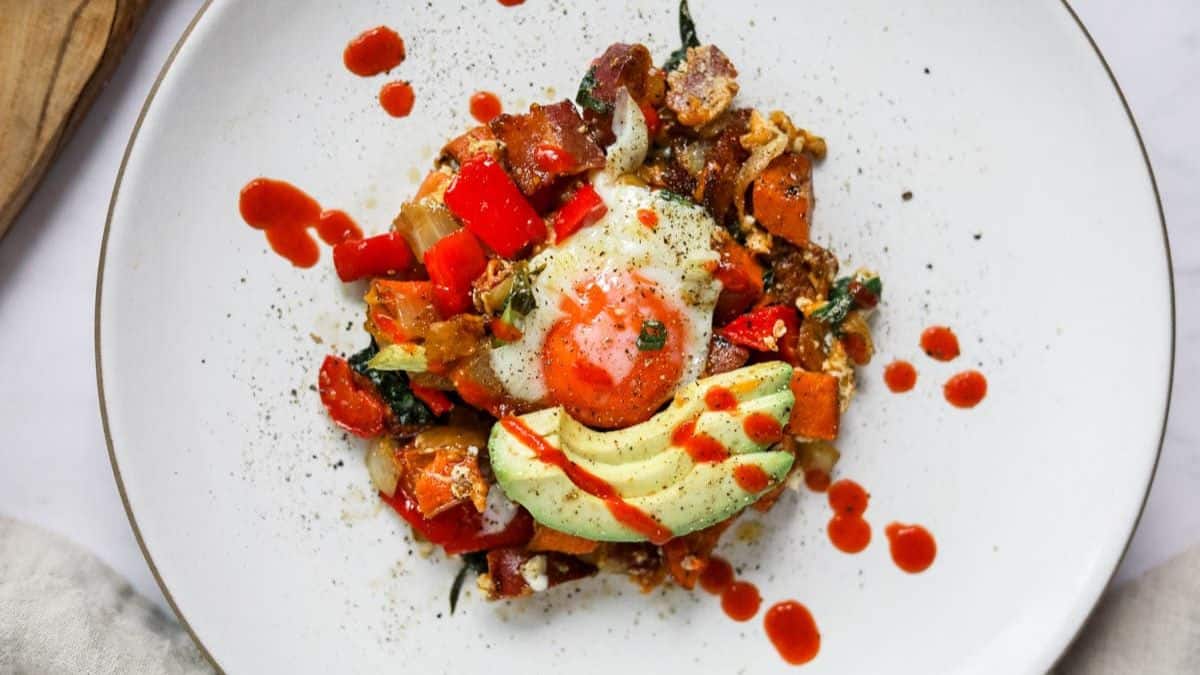 Breakfast hash with sweet potatoes and eggs with spinach.