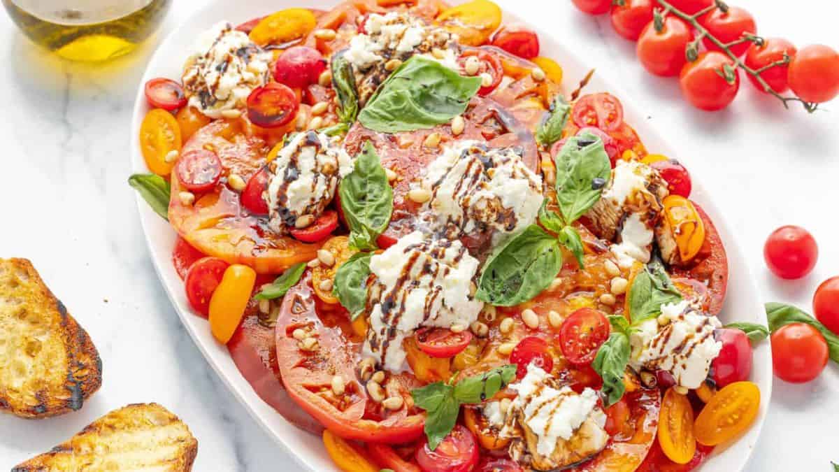 Burrata Caprese Salad with Balsamic Glaze, served on a plate. 