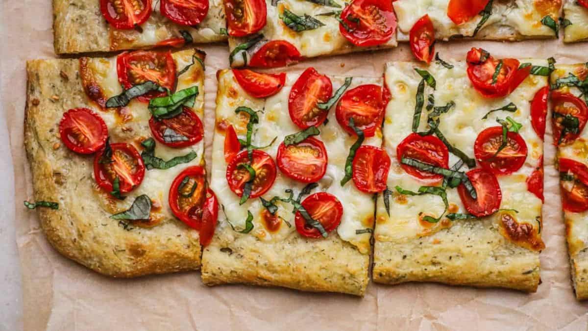 A few slices of cherry tomato, mozzarella, and basil pizza.