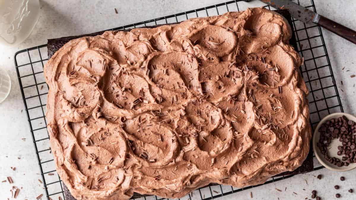Chocolate mousse cake on a cooling rack. 