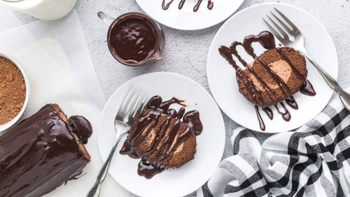 Few servings of chocolate roll cake drizzled with some chocolate ganache.