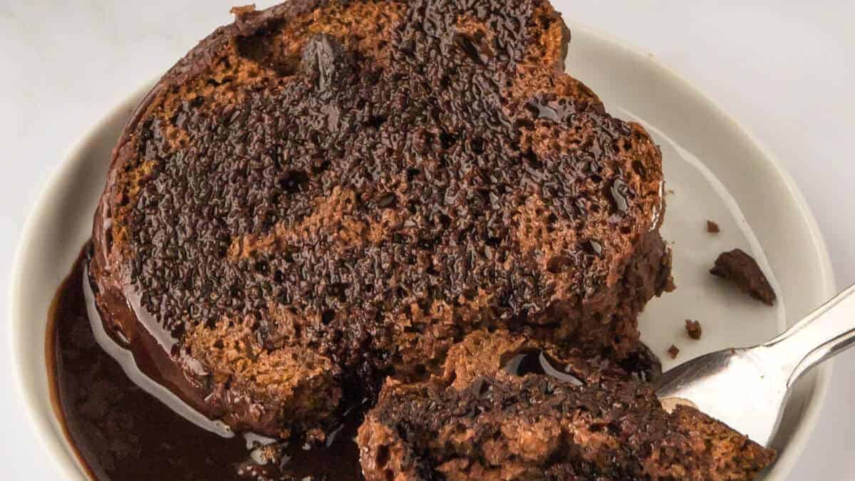 A slice of chocolate rum cake served on a plate.  