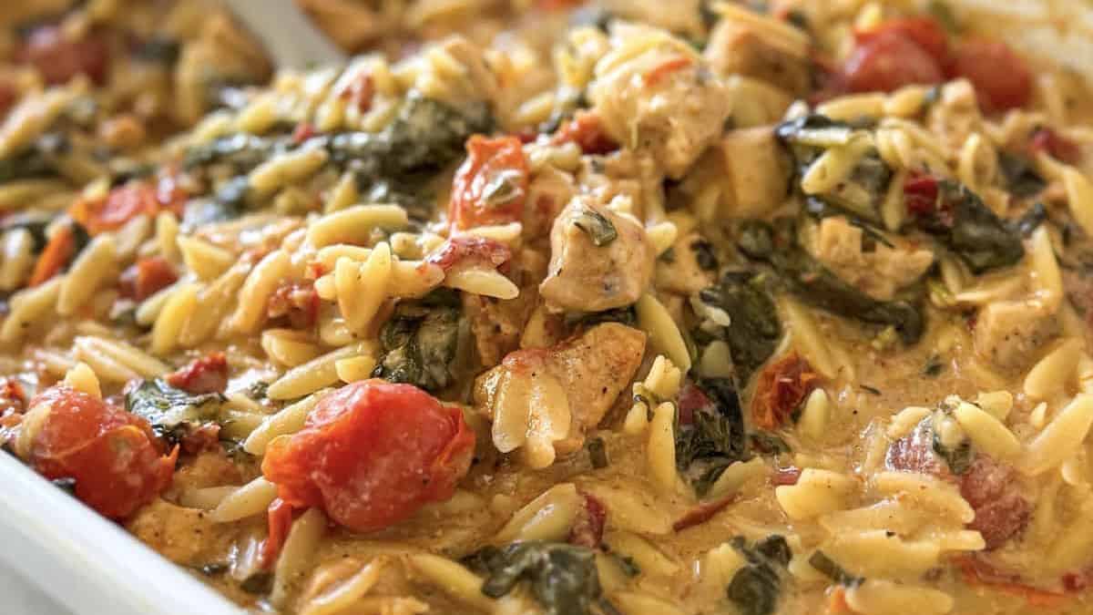 Tuscan style creamy chicken orzo bake in a casserole.