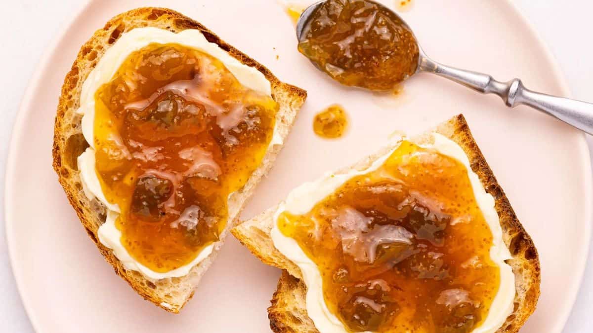 A toast with some cream and fig jam on top.