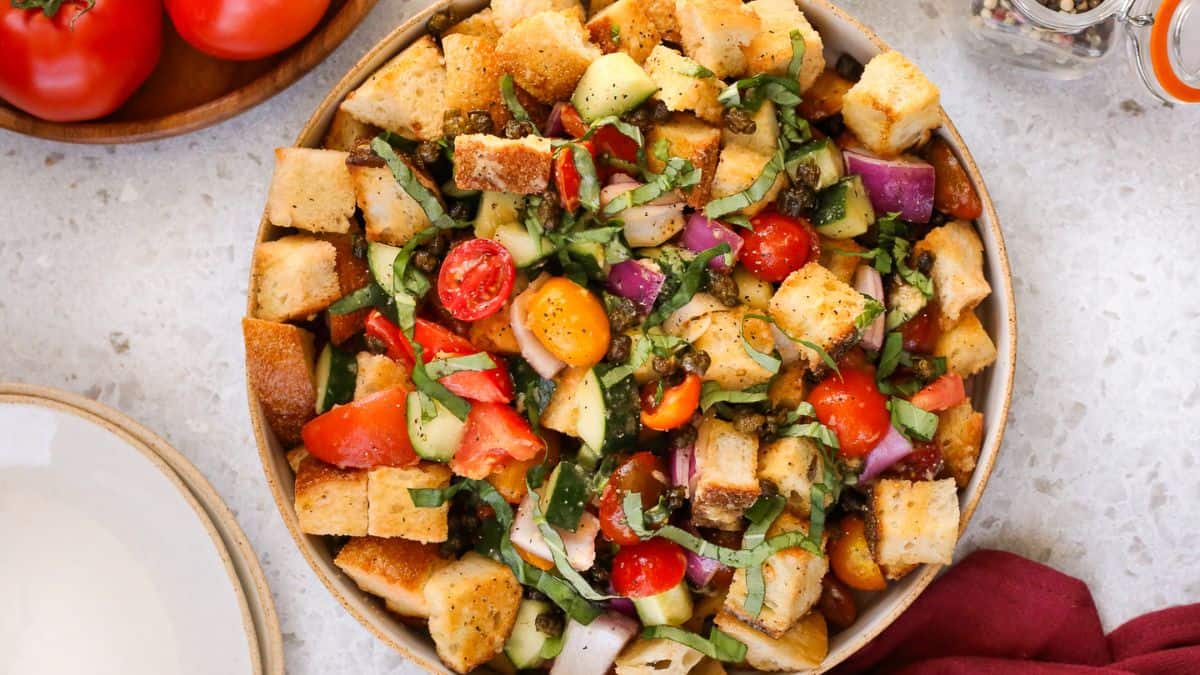 Panzanella Salad with Crispy Capers and Tinned Fish served in a bowl. 