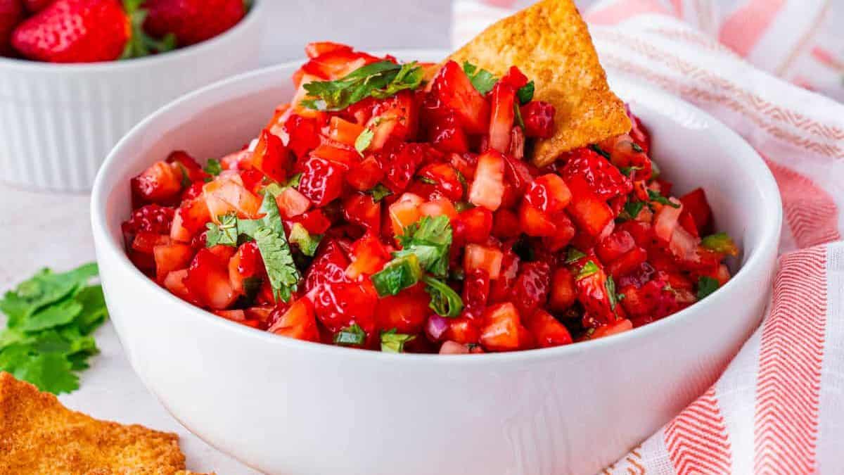 A bowl of fresh strawberry fruit salsa (dip or topping).