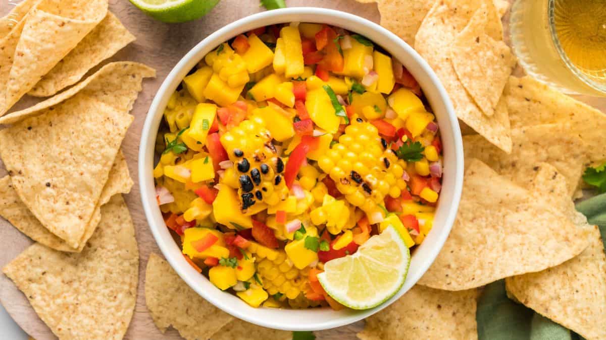 A bowl of grilled corn and mango salsa.