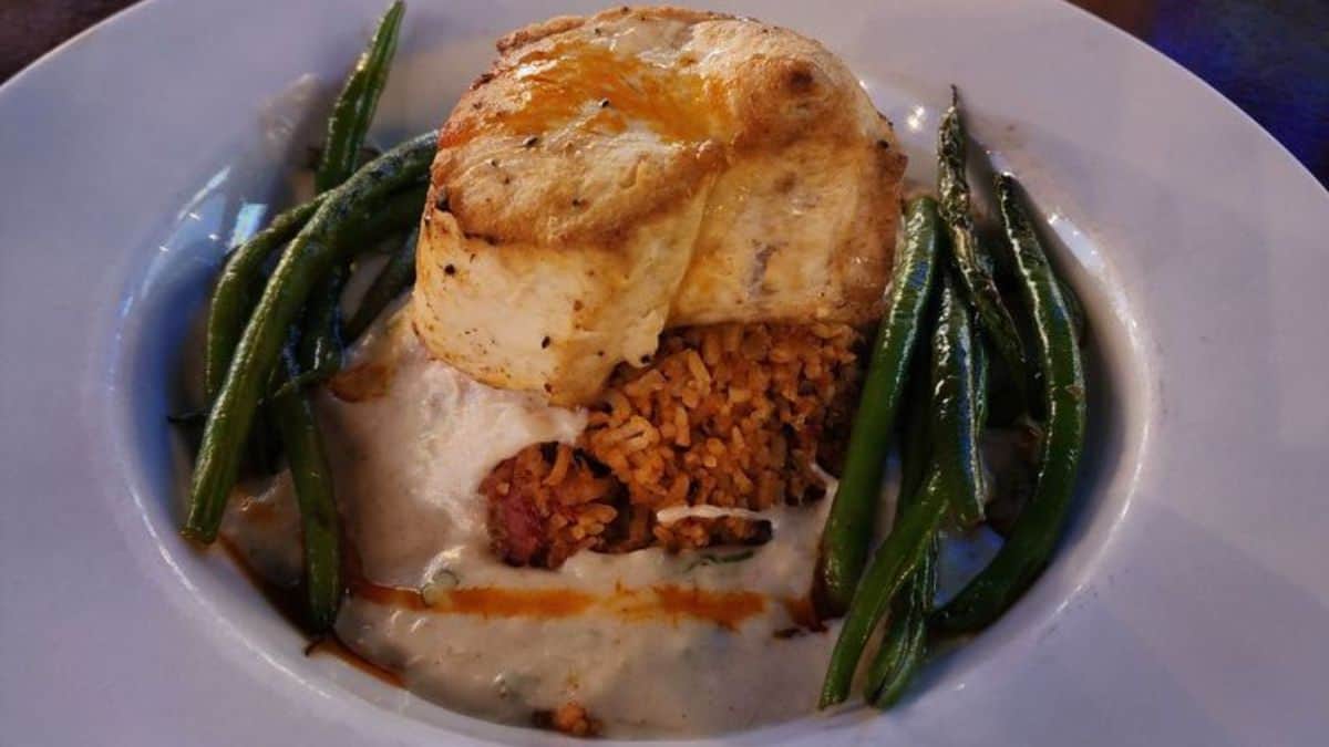 Pan-seared local swordfish over jasmine rice & beans with a sherry cream crab sauce over asparagus.