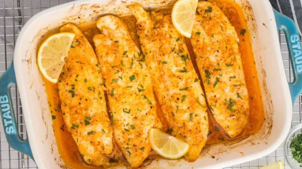 Lemon butter baked tilapia in a baking dish. 