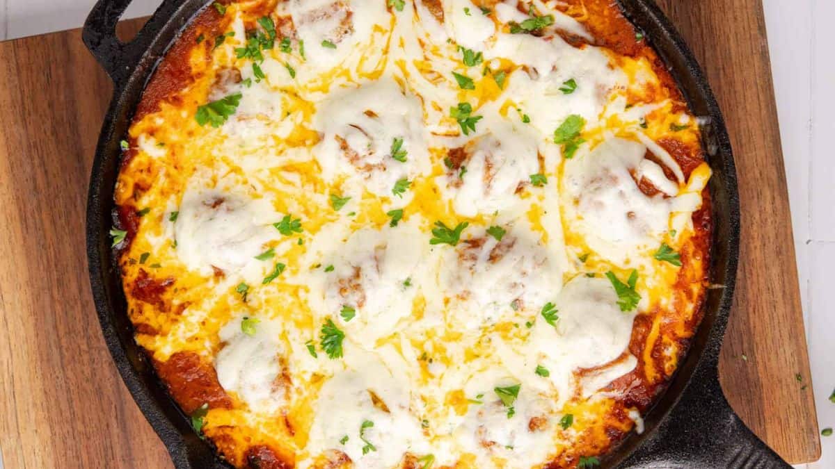 Meatball Parmigiana in a skillet.