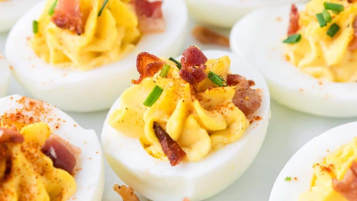 A few pieces of million dollar deviled eggs served on a plate.
