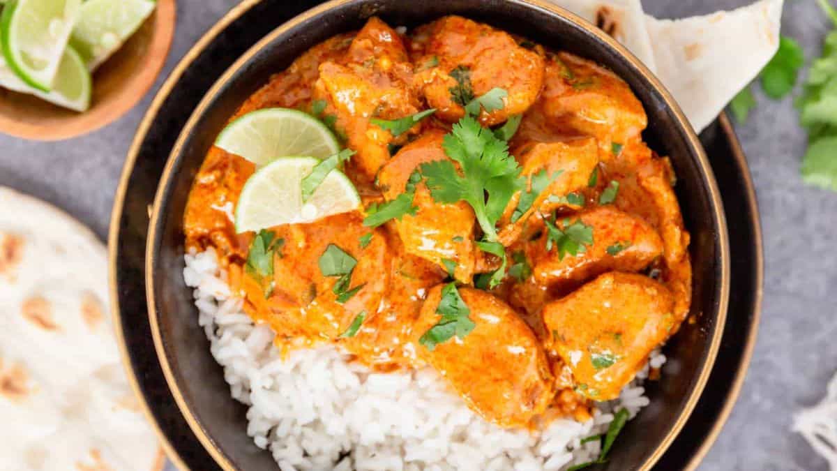 One pot butter chicken masala with coconut milk poured over a steamed white rice.