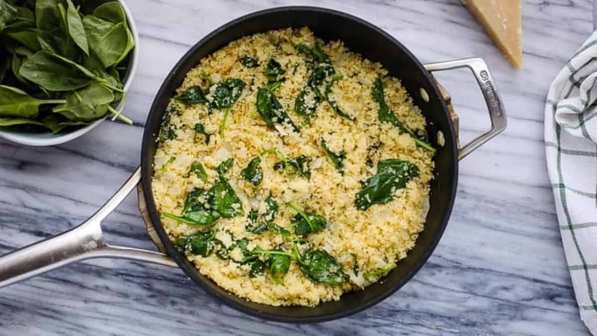 Parmesan spinach couscous in a pan.