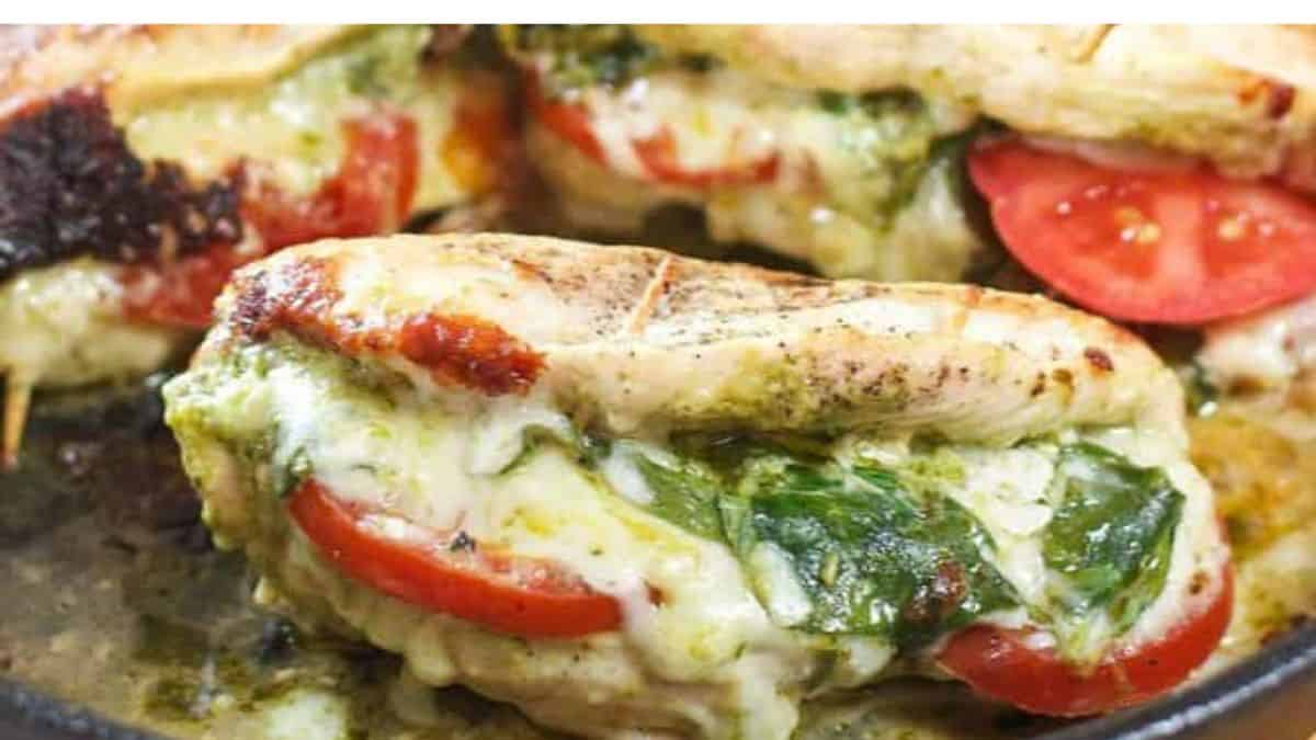 A serving of pesto, mozzarella, and tomato-stuffed chicken breasts.