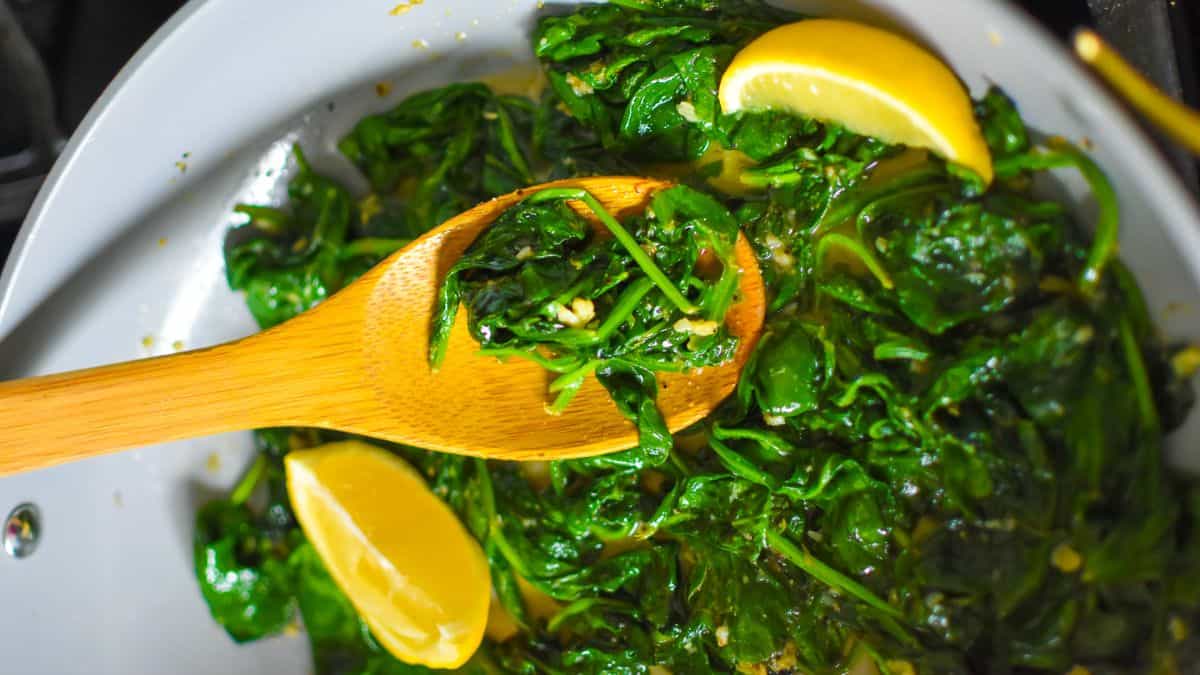 Skillet garlicky spinach with sliced lemons.