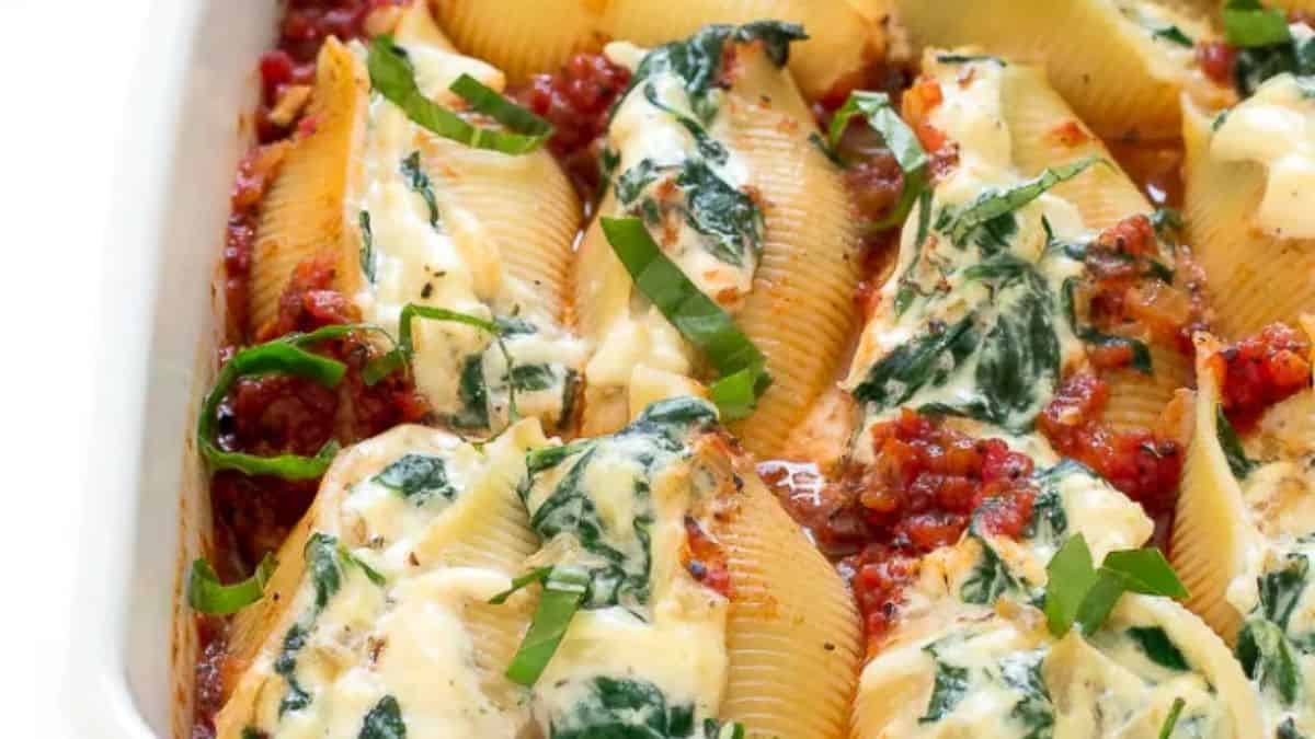 Spinach and ricotta stuffed shells in a baking dish.