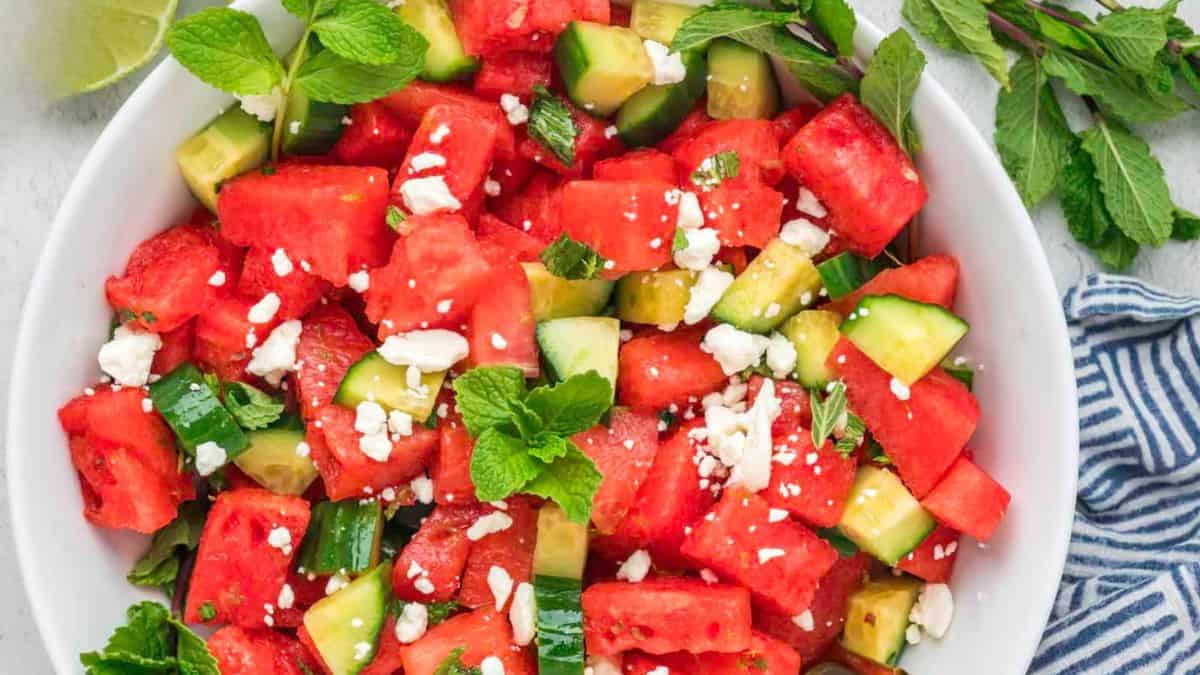 A bowl of summer watermelon salad with mint and cucumber.