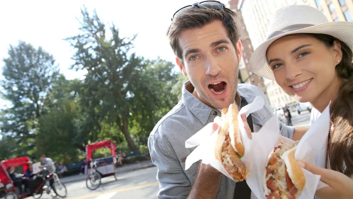 couple eating hot dogs in New York
