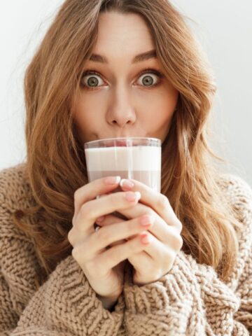 excited woman drinking coffee latte