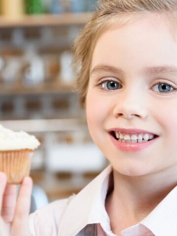 little girl with cupcake