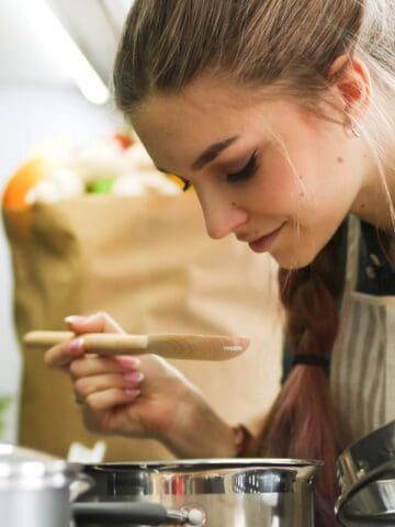 woman cooking over a stove
