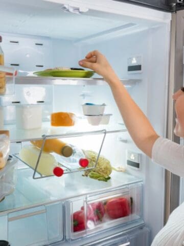 woman looking in fridge