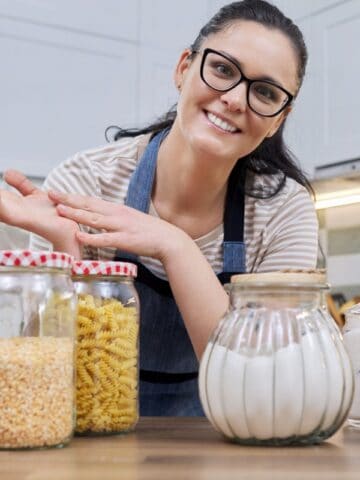 woman showing food storage in jars