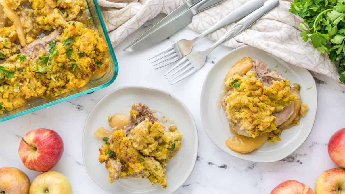 Oven-baked pork chops are served on plates. 