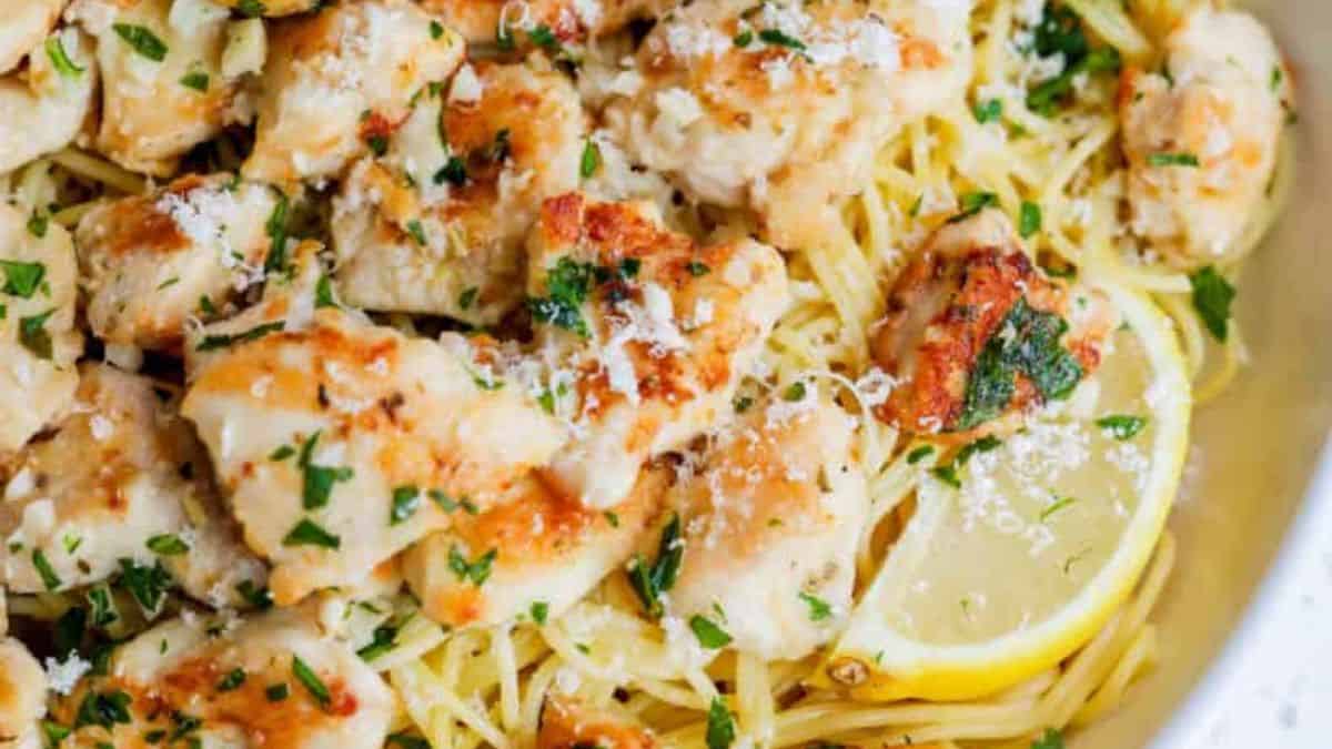 Chicken Scampi served with lemon wedges.