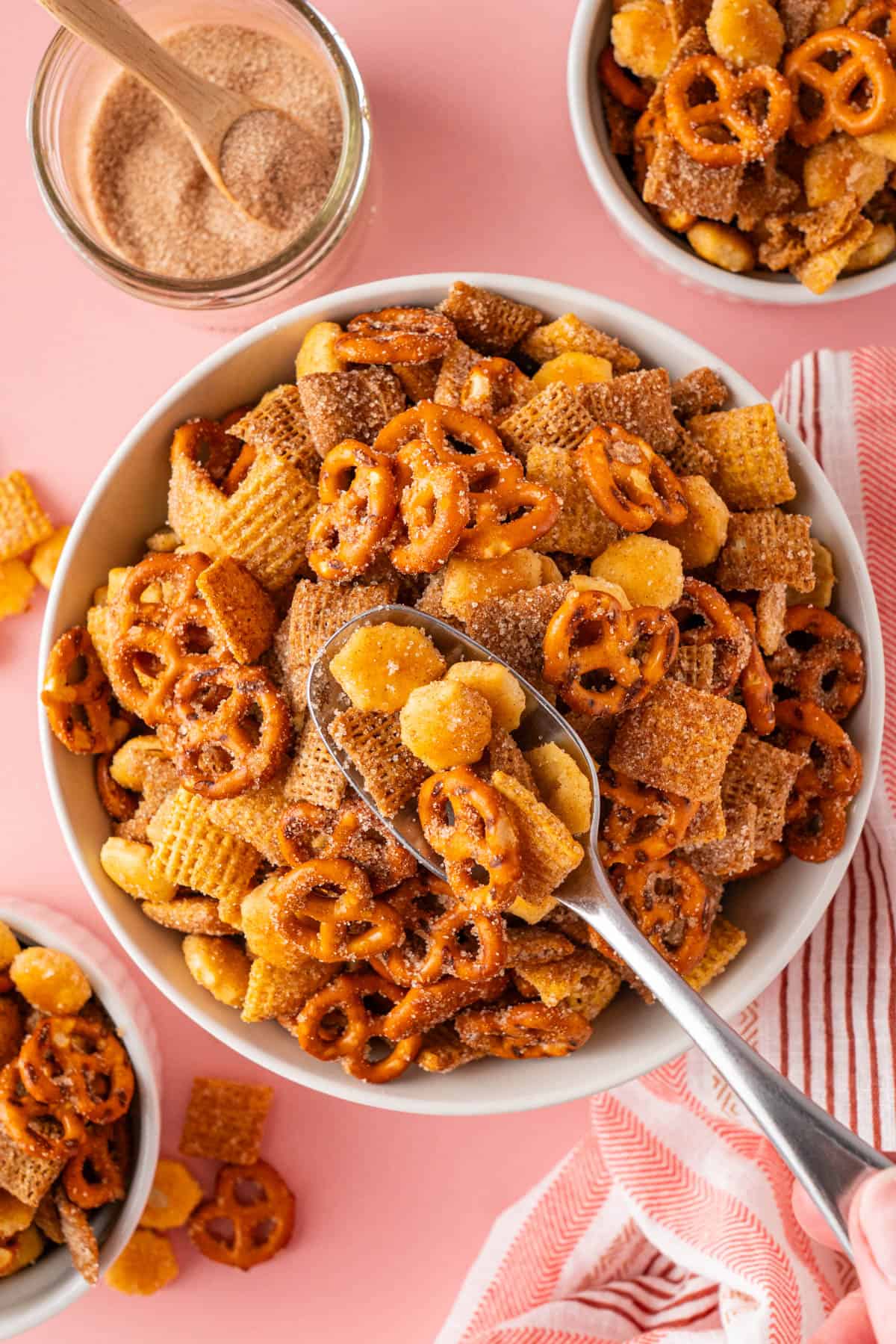 overhead shot of a spoonful of Churro Chex Mix With Cinnamon Sugar