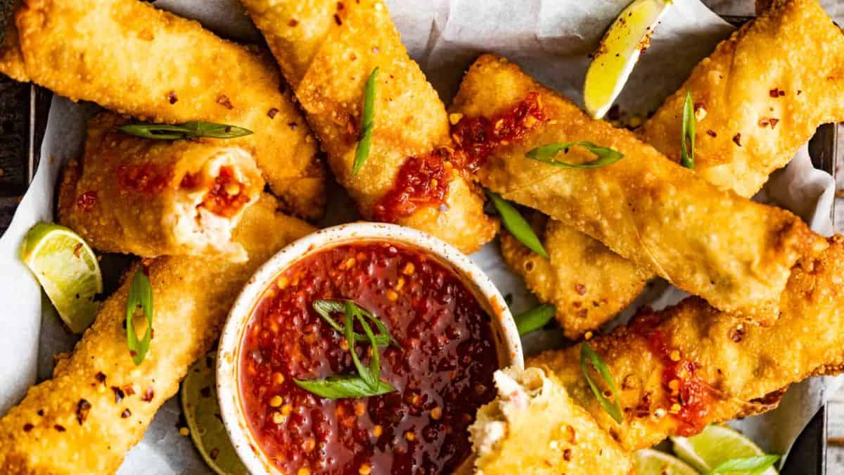 Crab Rangoon Egg Rolls served with sweet and sour sauce dip.