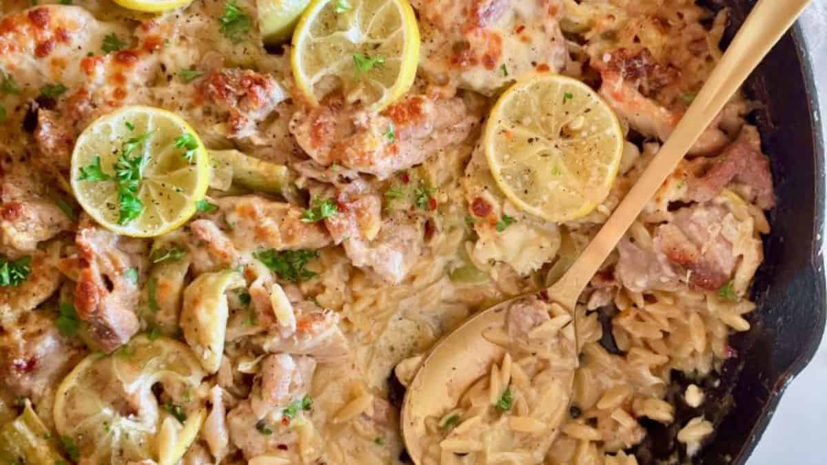 Easy Chicken Orzo Bake with Lemon, Parmesan & Artichokes in a pan.