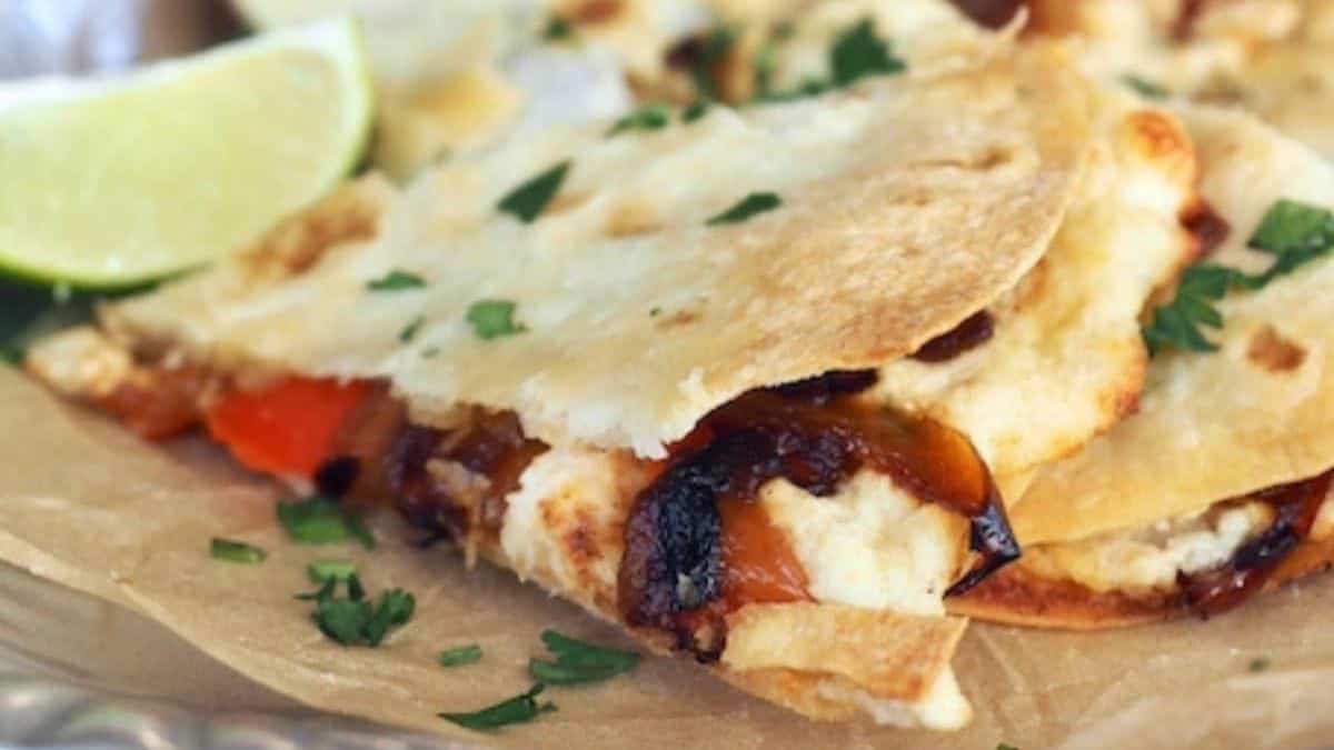 Easy Chicken Quesadillas (Baked) served with lime wedges.
