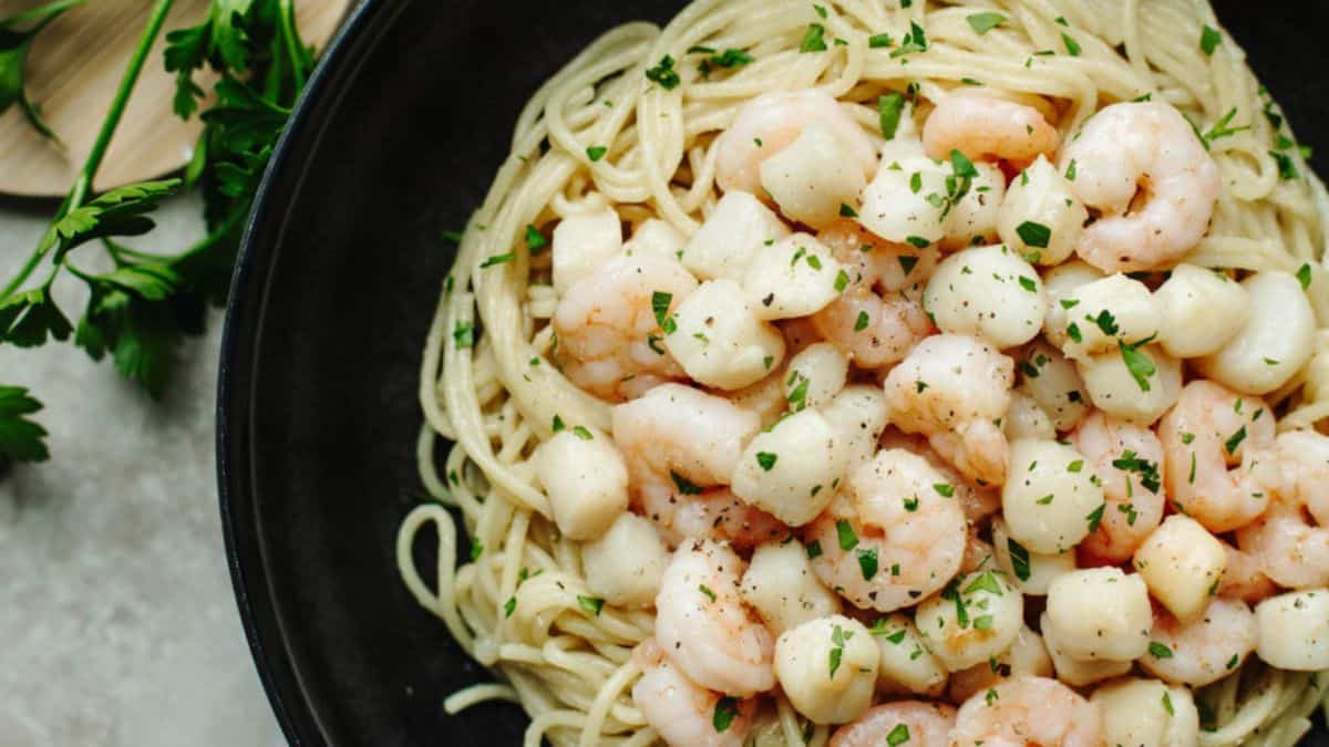 Garlic Butter Shrimp and Scallops served on top of spaghetti pasta.