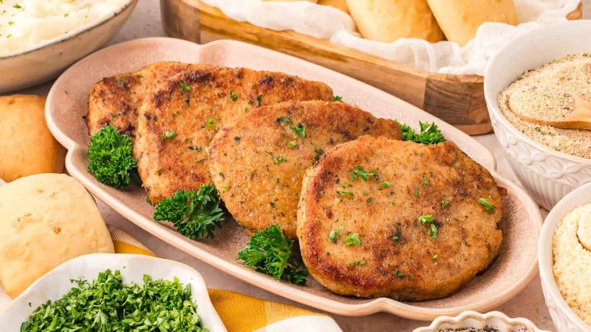 A few pieces of Parmesan Crusted Pork Chops served on a plate. 
