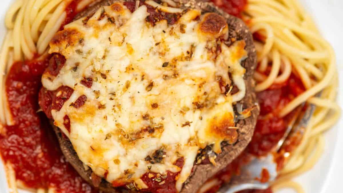 Portobello Mushroom Parmesan served on top of tomato spaghetti pasta. 