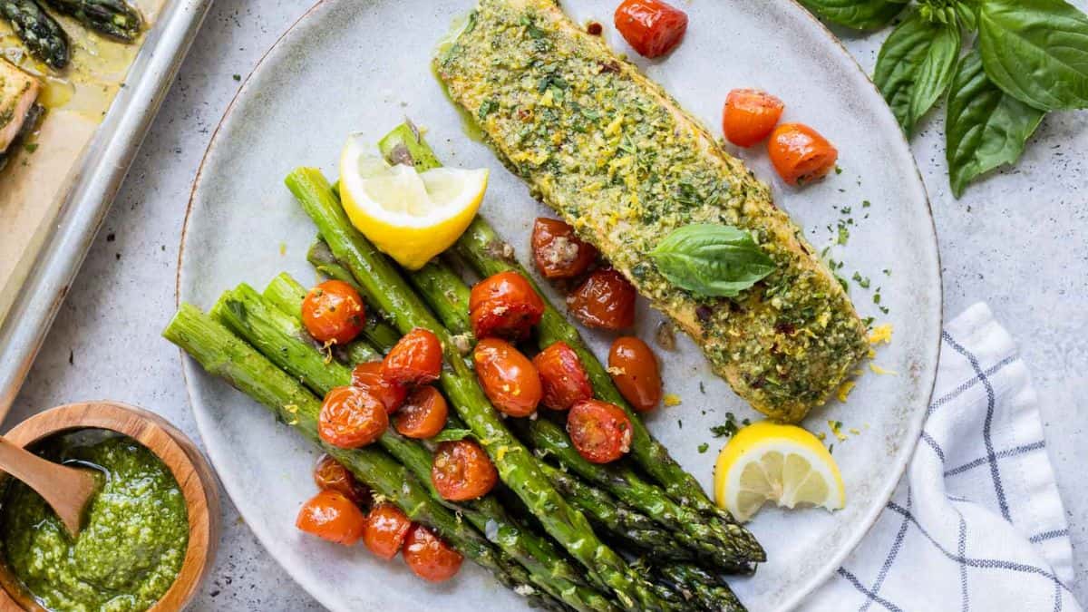 A single serving of Sheet Pan Salmon and Asparagus with Pesto.