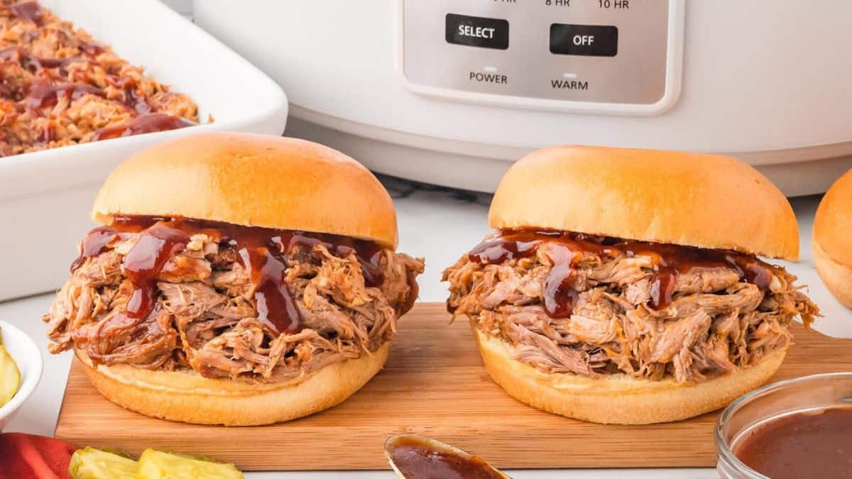 Two servings of Slow Cooker Pulled Pork served with some BBQ glaze.