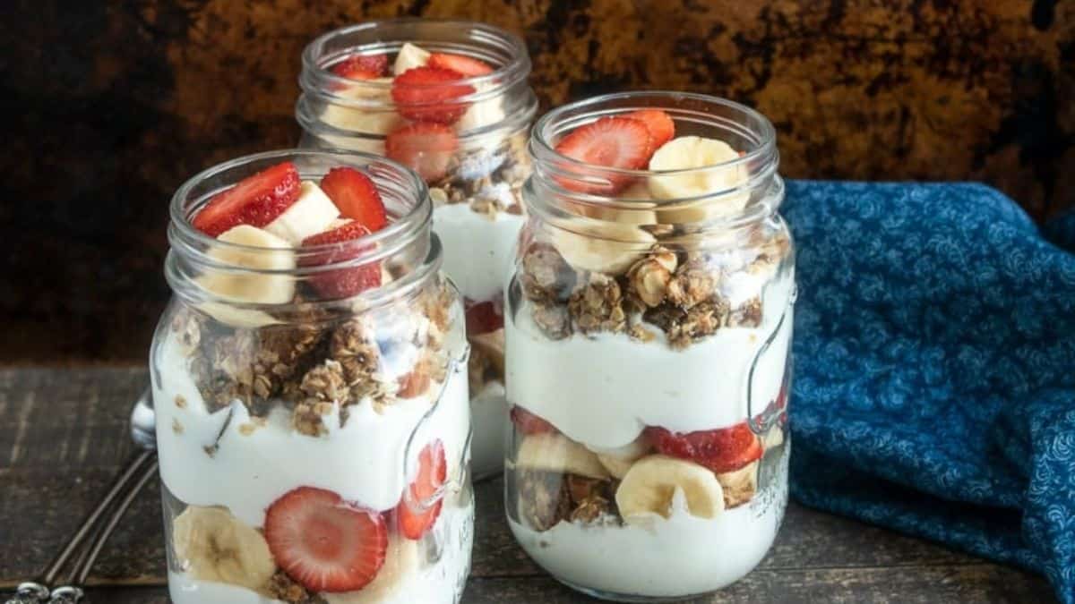 A few servings of Strawberry Banana Parfait with Homemade Granola in a jar.