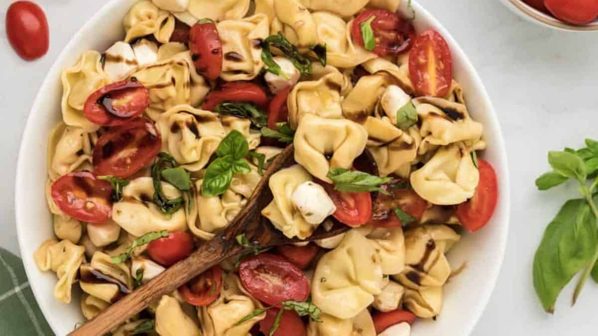 Tortellini Caprese Pasta Salad With Balsamic served in a bowl.