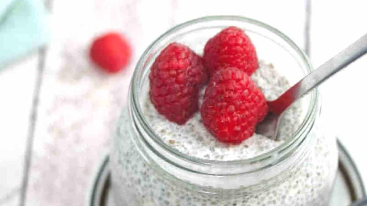 Vanilla Keto Chia Pudding in a mason jar topped with some raspberries.