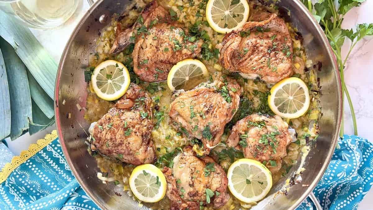 White Wine Oven Roasted Chicken Thighs and Leeks in a pan.