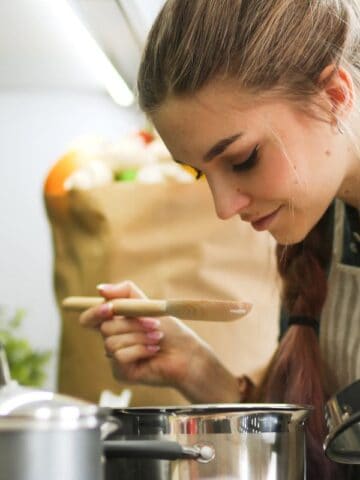 Woman smelling her food on the stove