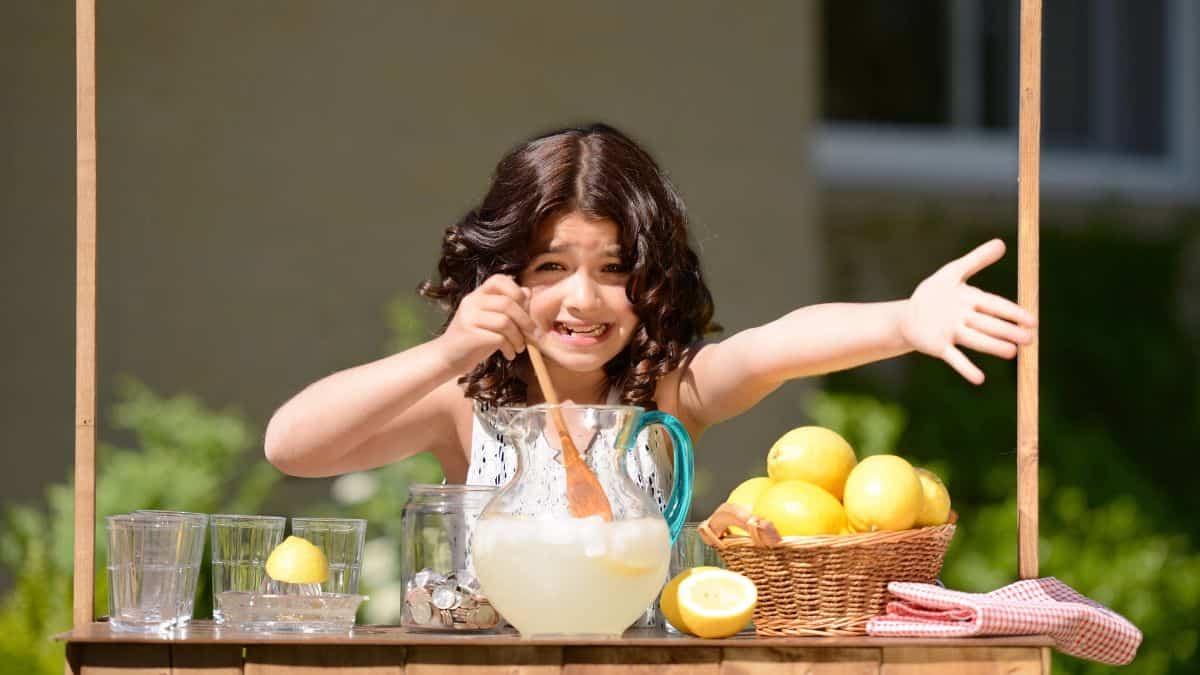 little girl making lemonade