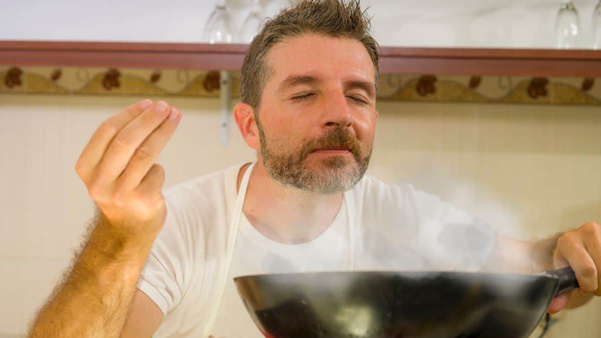 man cooking with pan