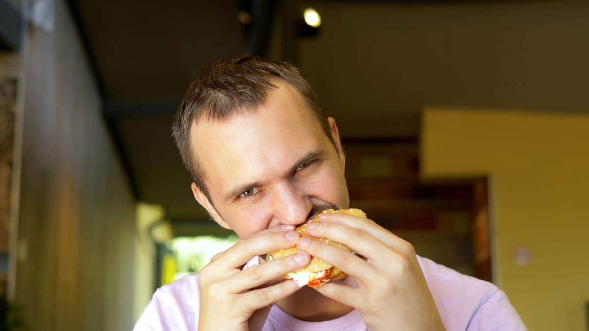 man eating burger