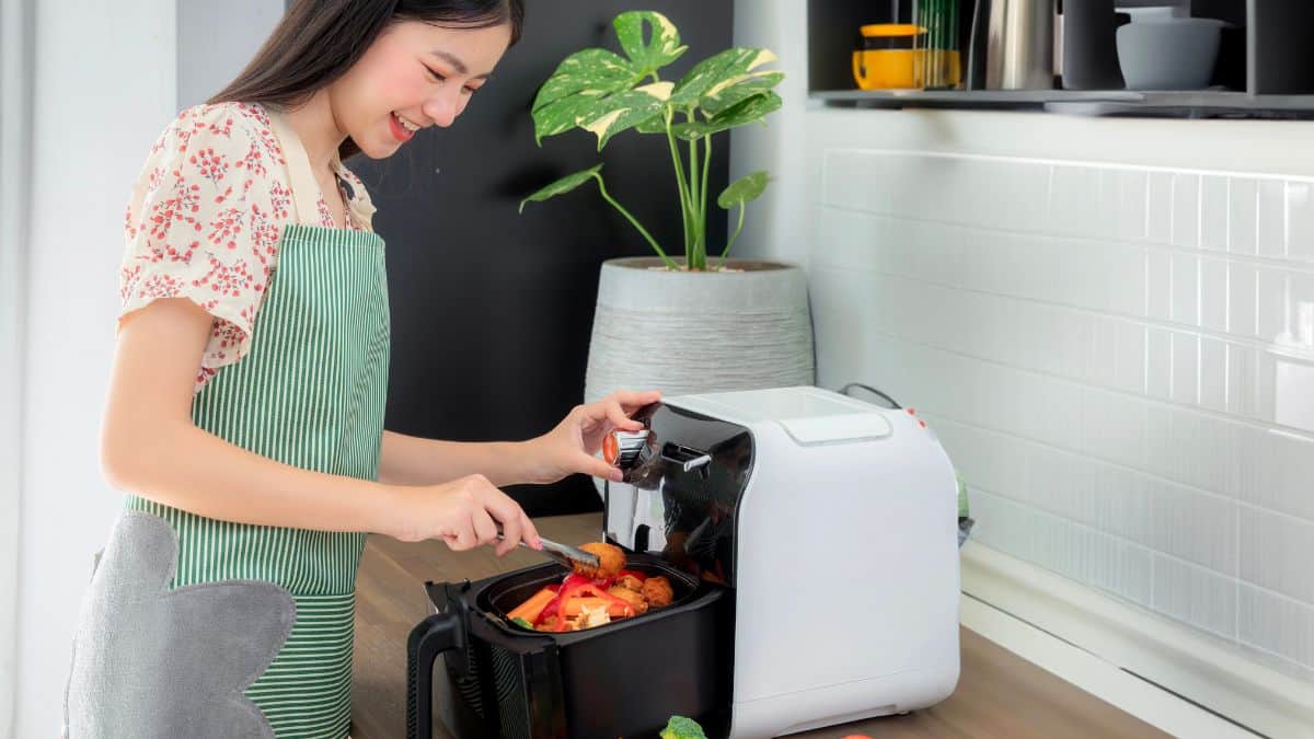 woman cooking with air fryer