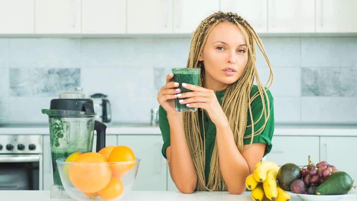 woman drinking green smoothie