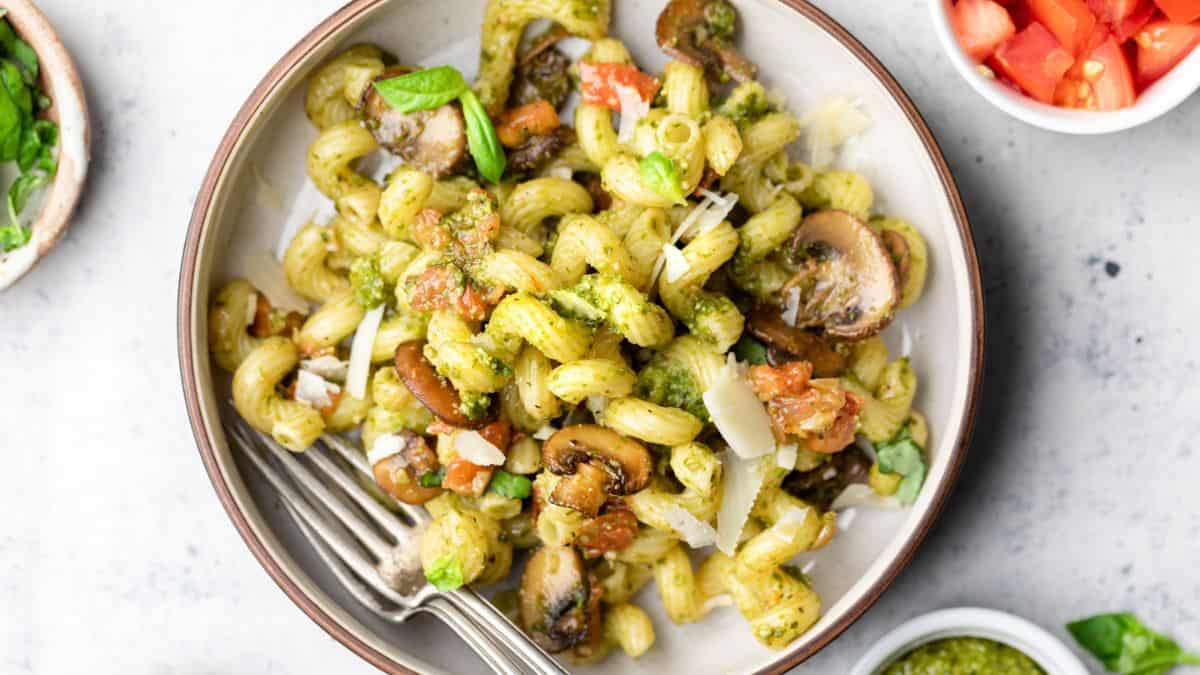 A serving of 30 Minute Pesto Pasta with Mushrooms and Tomatoes.
