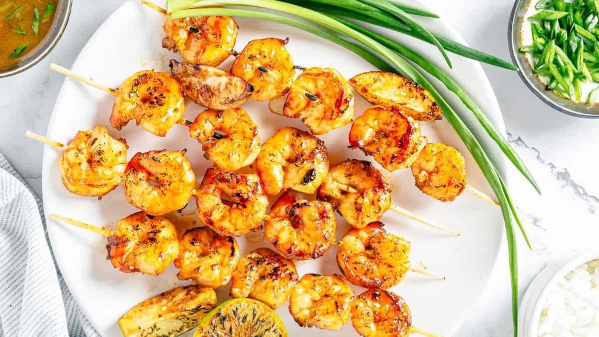 A serving of Asian Marinated Grilled Shrimp Skewers served on a plate. 